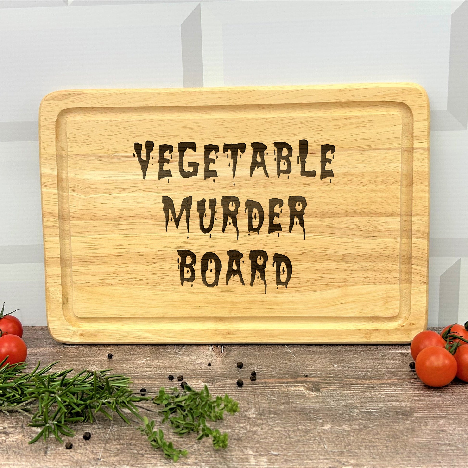 a cutting board with the words vegetable murder board on it