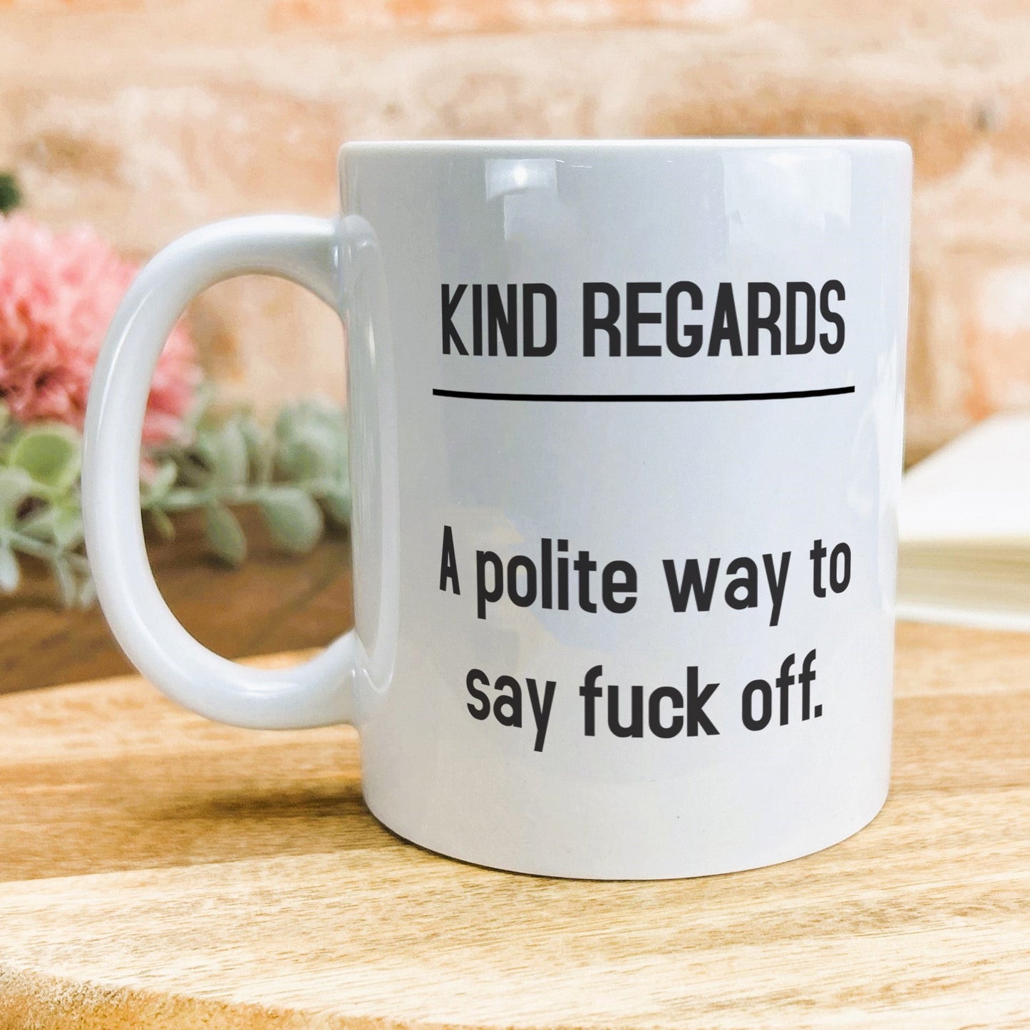 a white coffee mug sitting on top of a wooden table