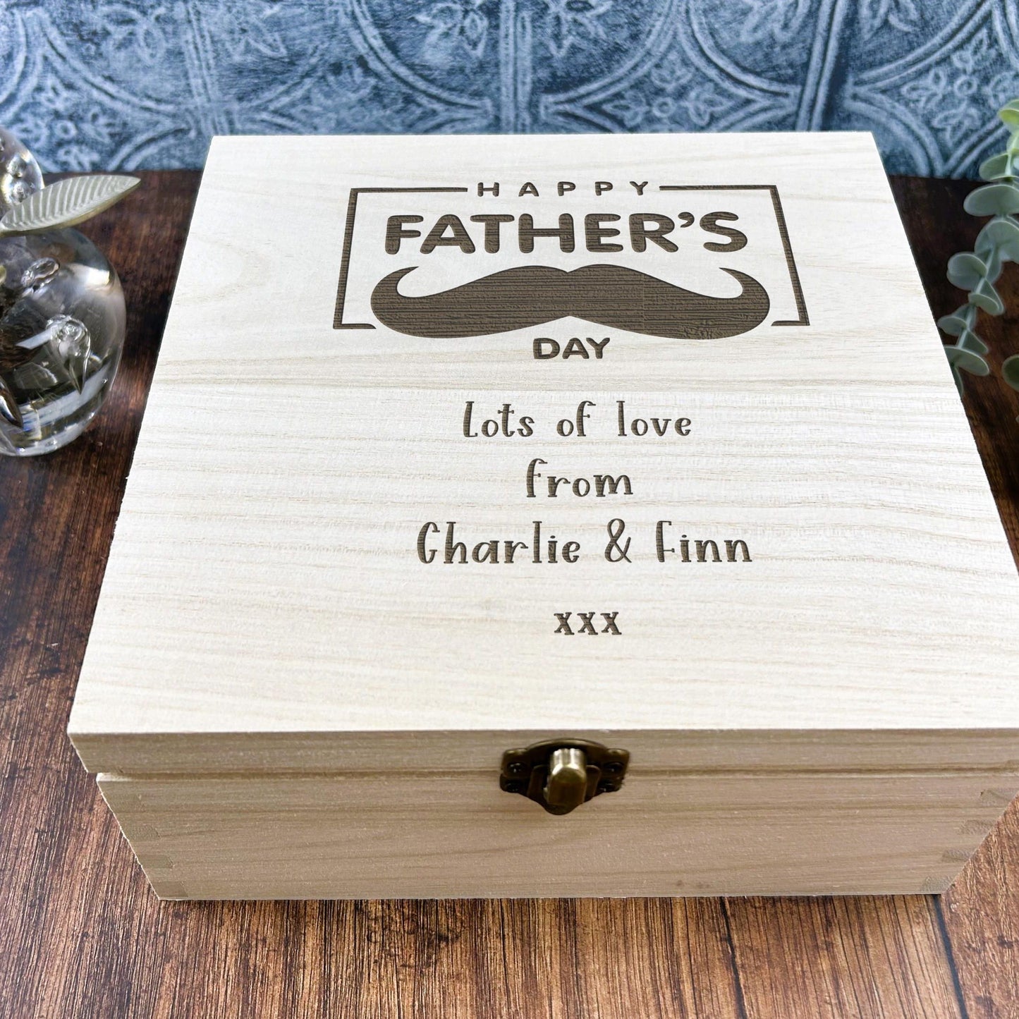 a wooden box with a picture of a mustache on it