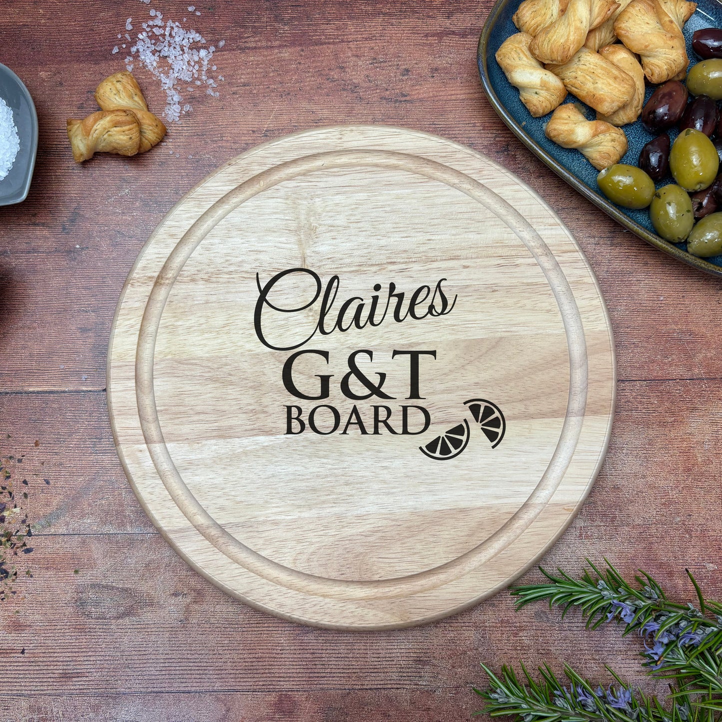 a wooden cutting board with the words g & t board on it