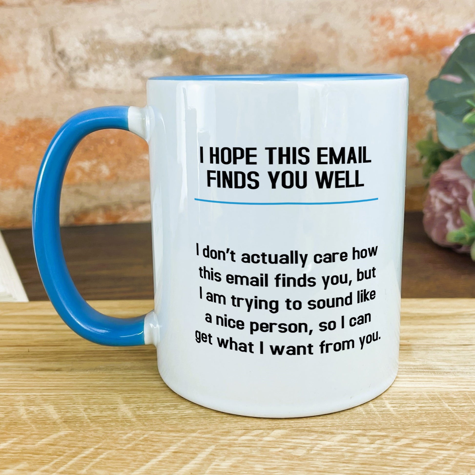 a blue and white coffee mug sitting on top of a wooden table