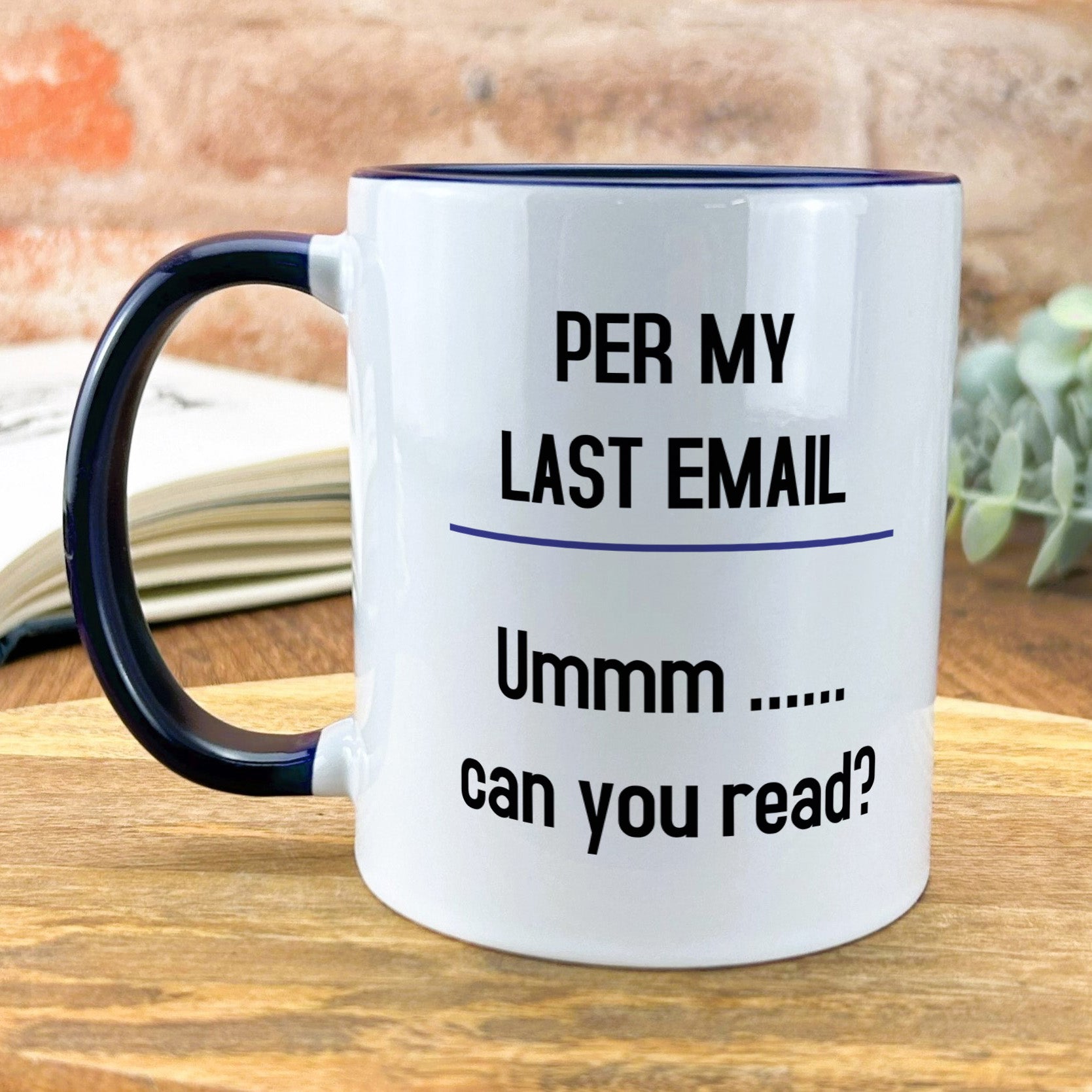 a black and white coffee mug on a wooden table