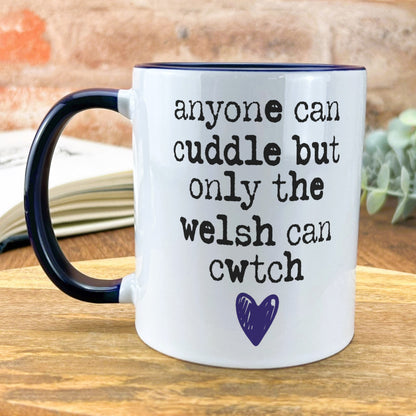 a black and white coffee mug sitting on top of a wooden table