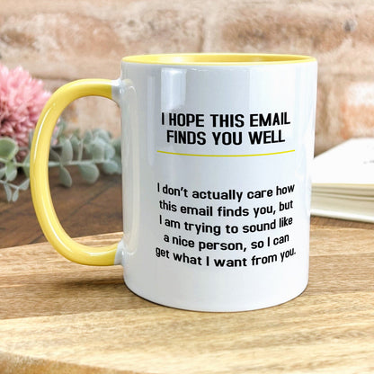 a yellow and white coffee mug sitting on top of a wooden table