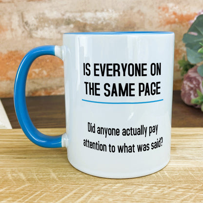 a blue and white coffee mug sitting on top of a wooden table