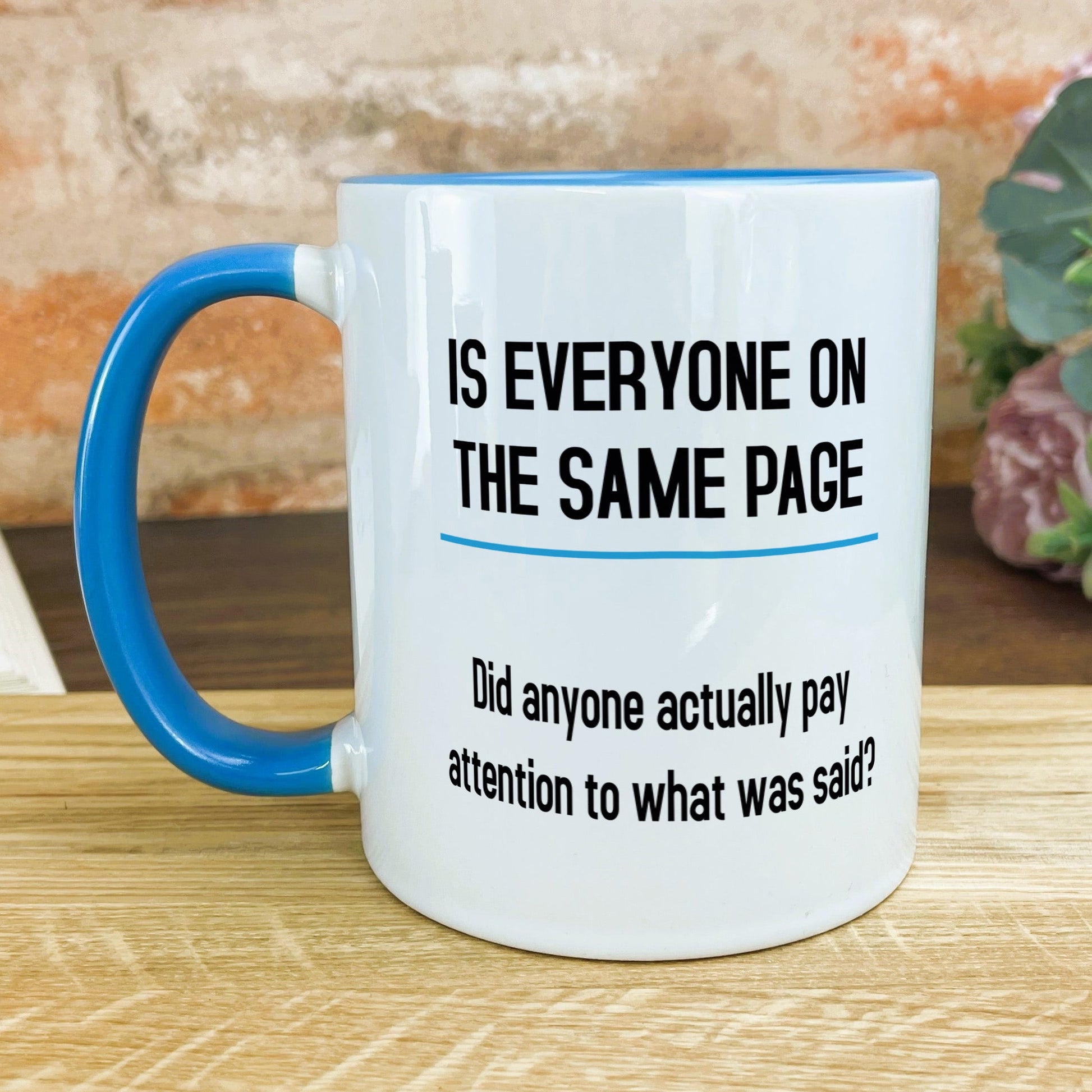 a blue and white coffee mug sitting on top of a wooden table