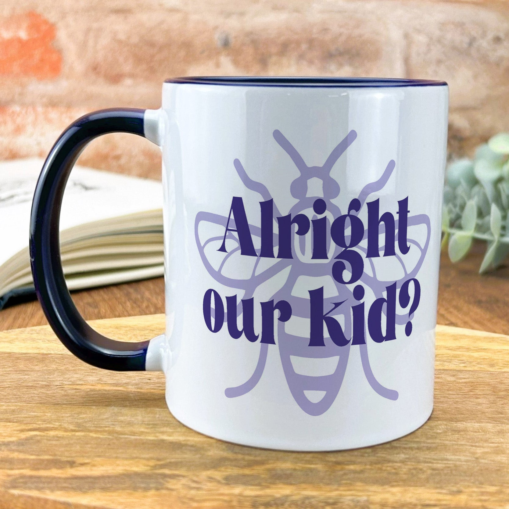a coffee mug with the words alright and a bee on it