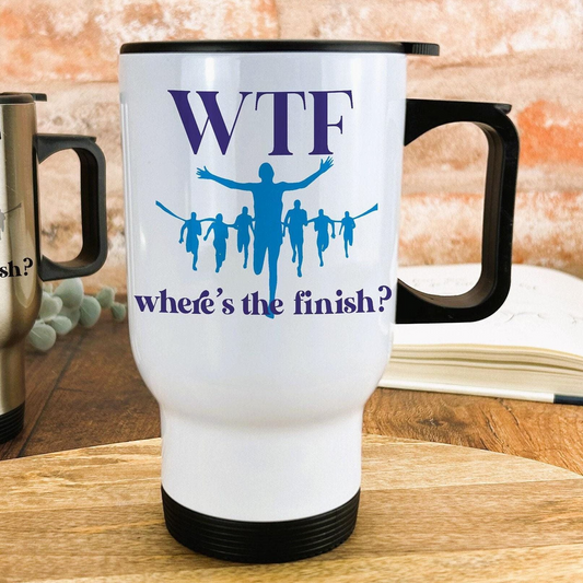 A white travel mug with a black handle, featuring a graphic design of a group of people running and the text "Where's the finish?"