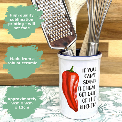 a cup with a red pepper on it and a grater in it