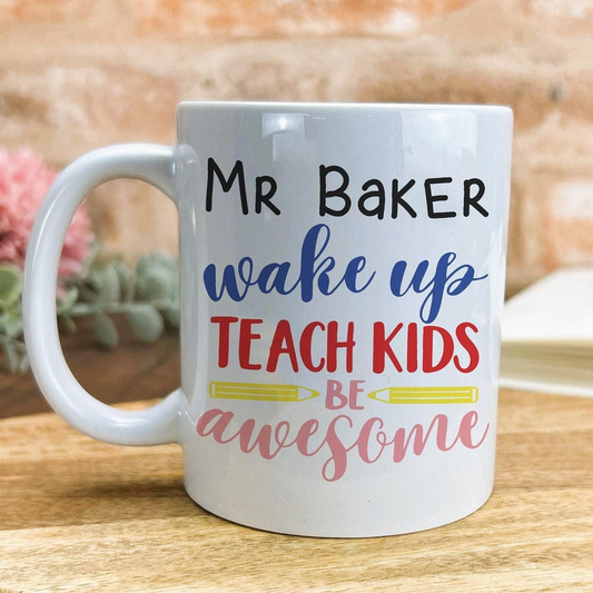 A white ceramic mug with text printed on it, placed on a wooden surface.