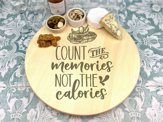 a wooden plate with a sign that says count the memories not the calories