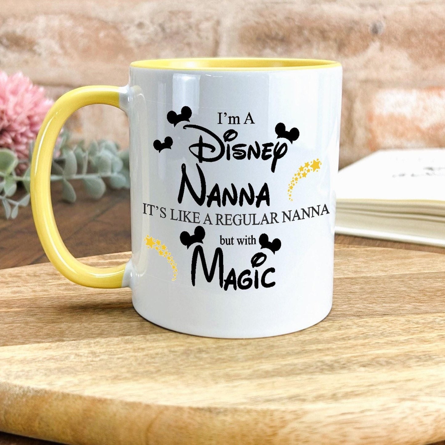 a yellow and white coffee mug sitting on top of a wooden table