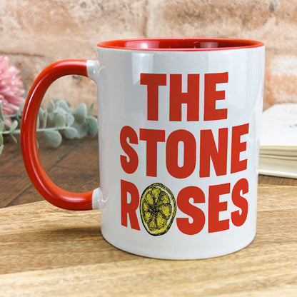a red and white coffee mug with the words the stone roses on it