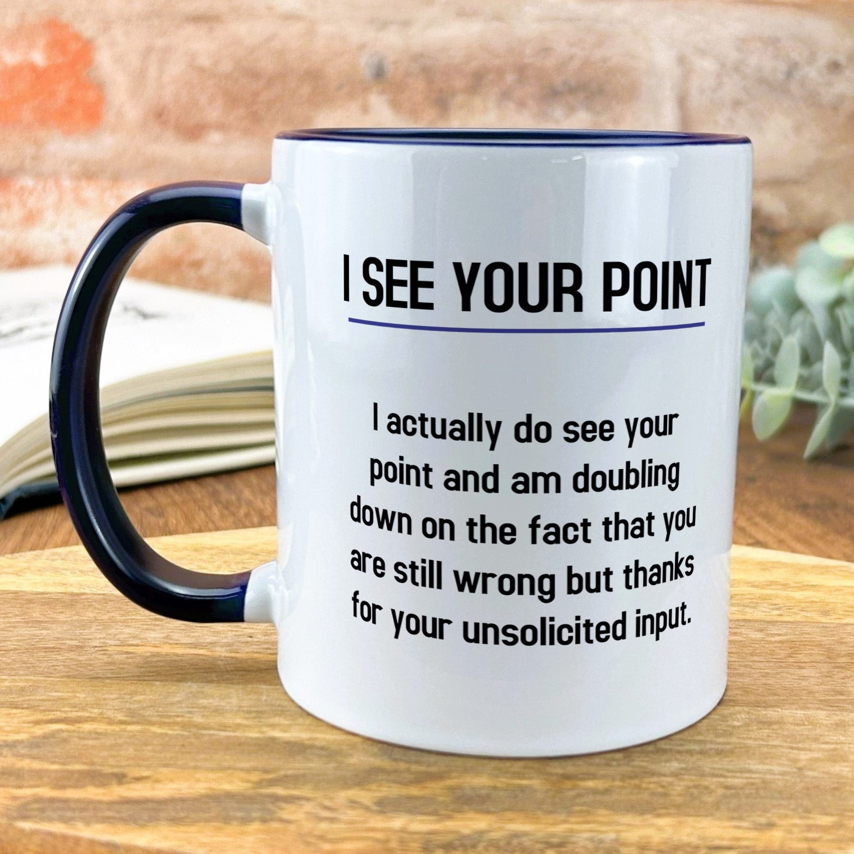 a black and white coffee mug on a wooden table