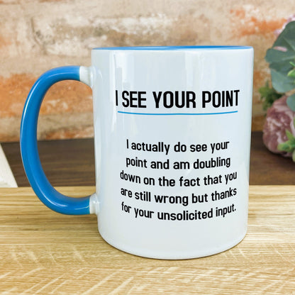 a blue and white coffee mug sitting on top of a wooden table