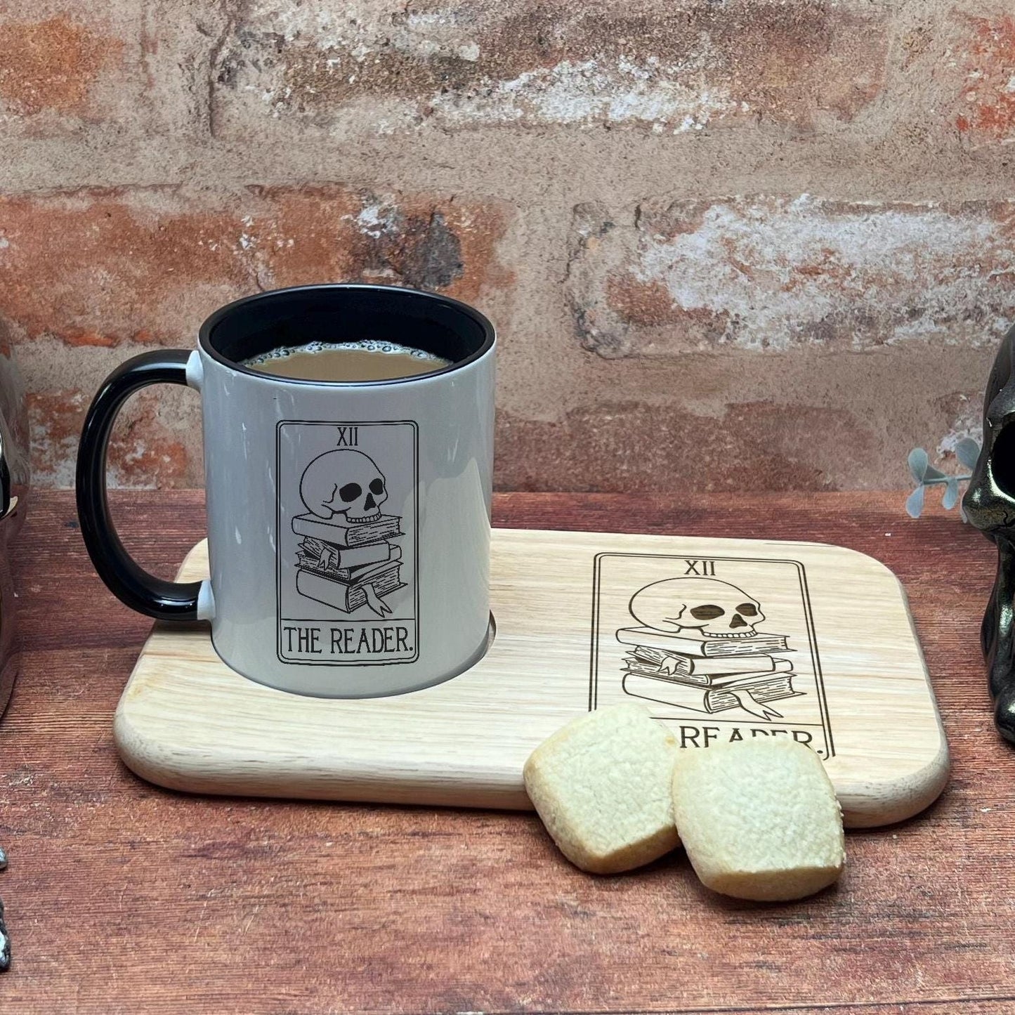 a cup of coffee next to a pair of skulls