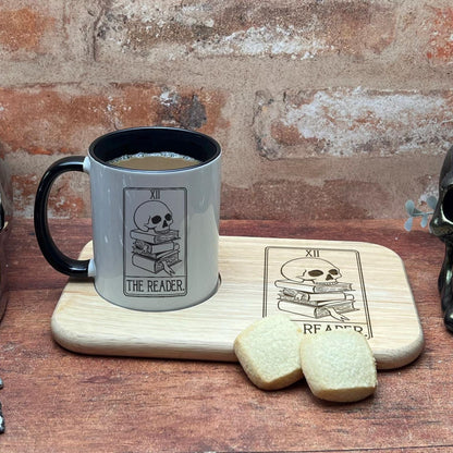 a cup of coffee next to a pair of skulls