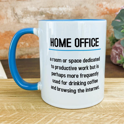 a blue and white coffee mug sitting on top of a wooden table