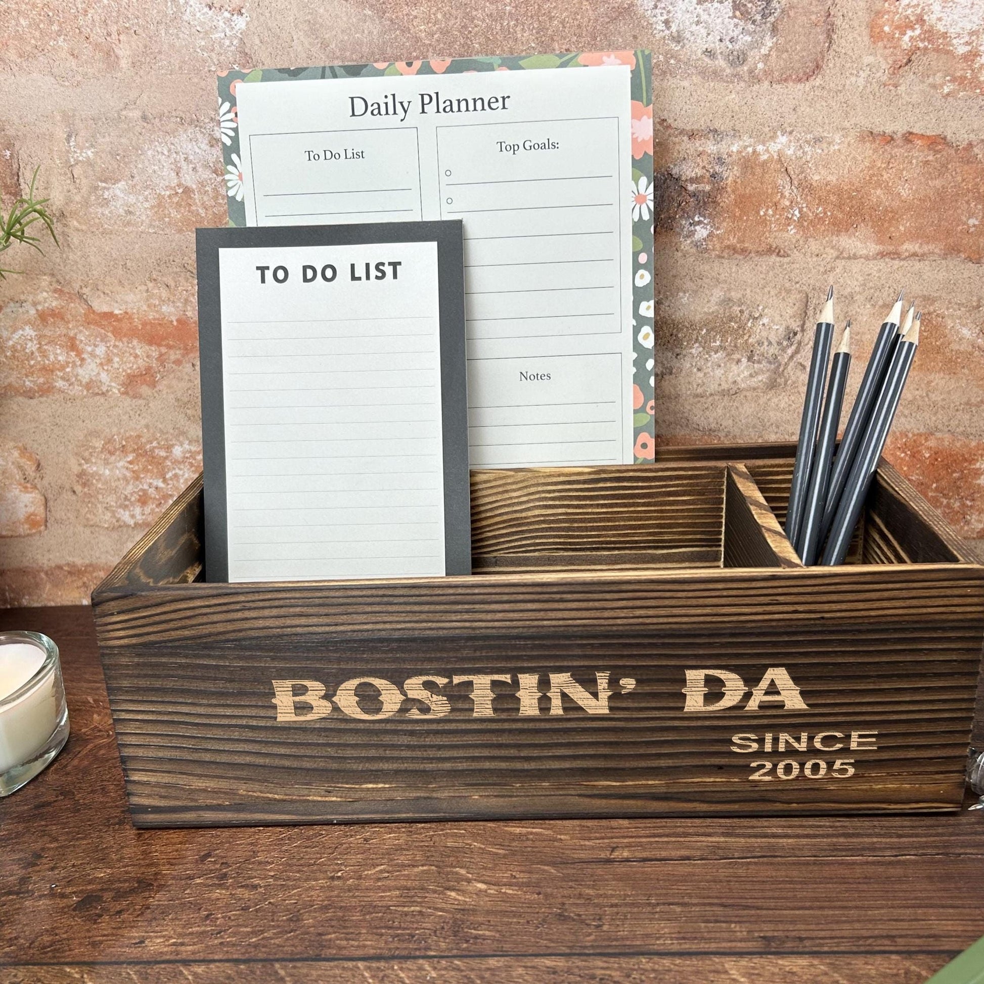 a wooden box with a notepad and pen holder