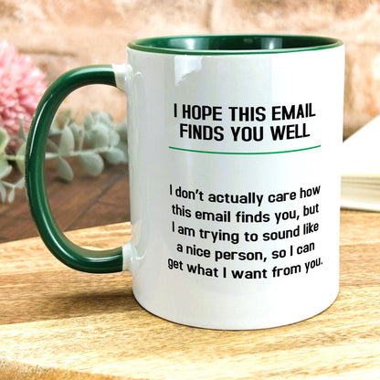 a green and white coffee mug sitting on top of a wooden table