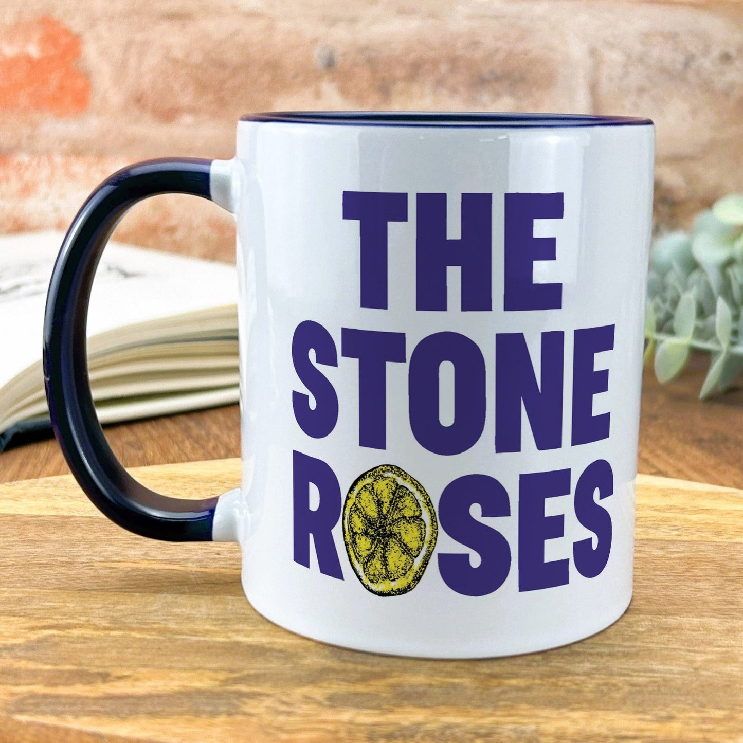 a coffee mug with the words the stone roses on it