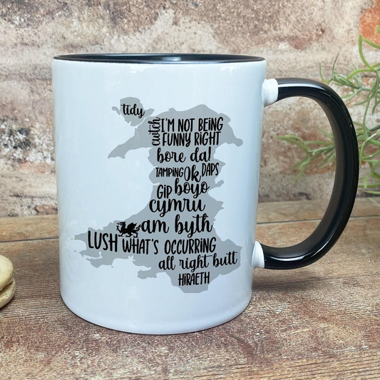 a white and black coffee mug sitting on top of a wooden table