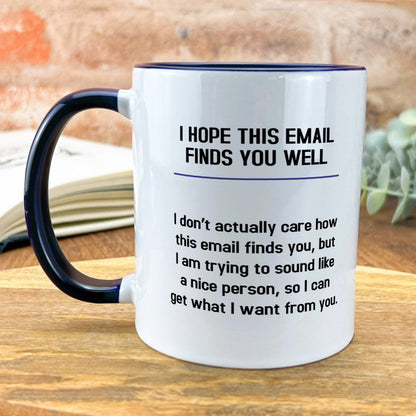 a white and black coffee mug sitting on top of a wooden table