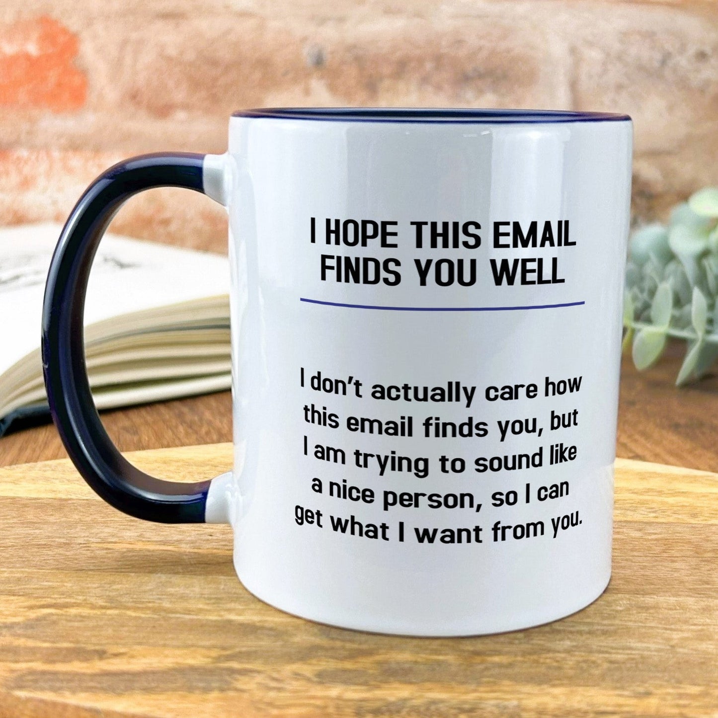 a white and black coffee mug sitting on top of a wooden table