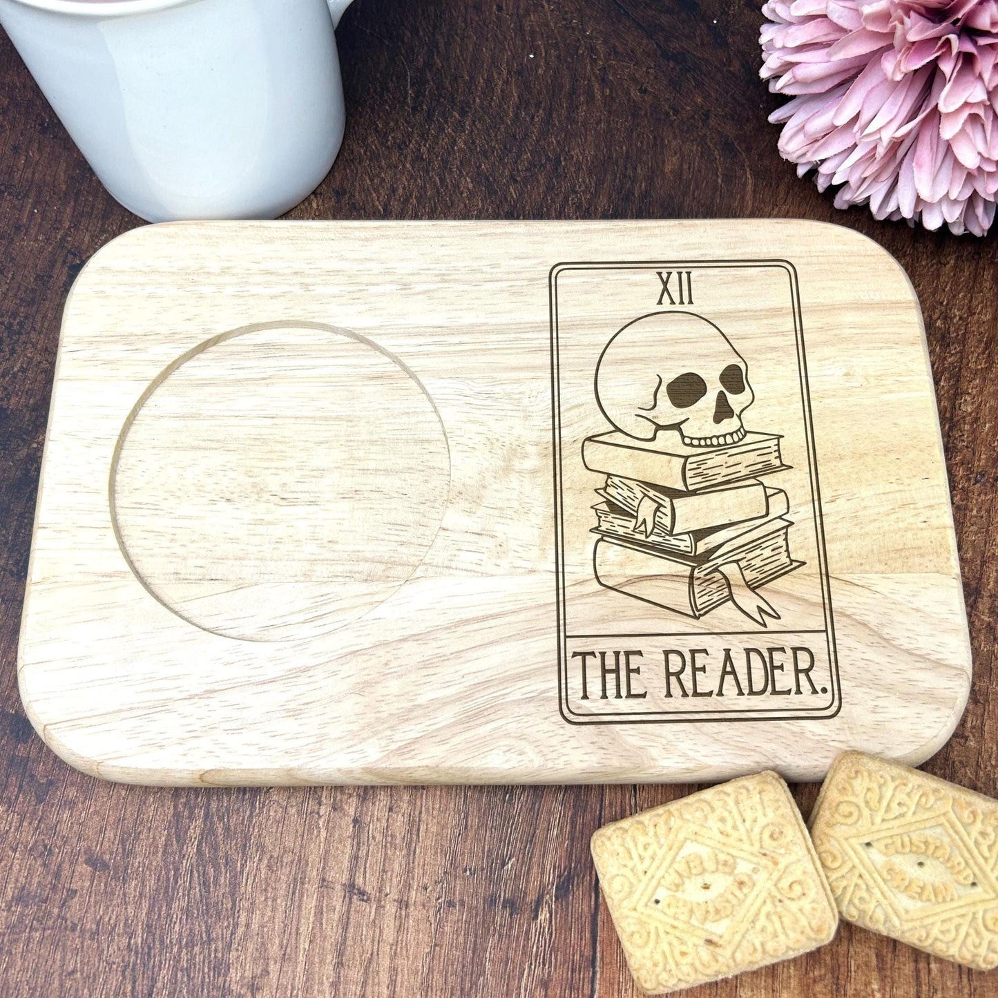 a wooden coaster with a picture of a skeleton reading a book