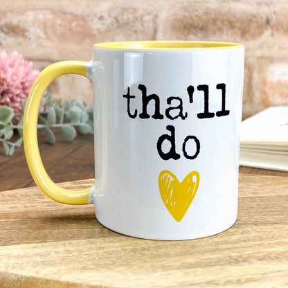 a yellow and white coffee mug with the words that i do on it