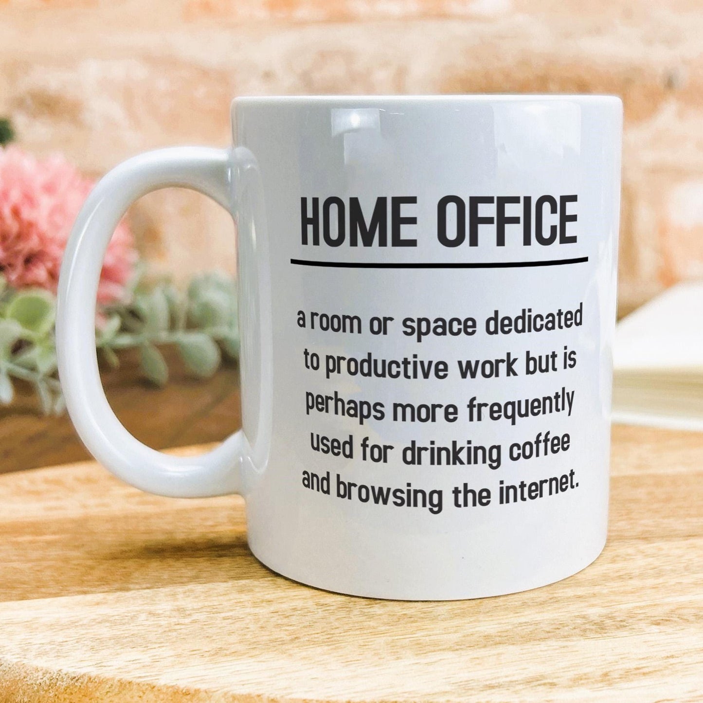 a coffee mug sitting on top of a wooden table