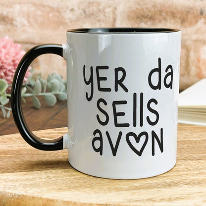 a black and white coffee mug sitting on top of a wooden table