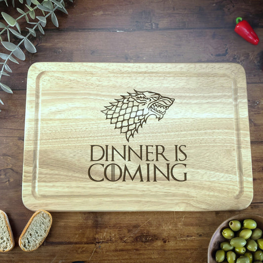 a wooden cutting board with a game of throne logo on it