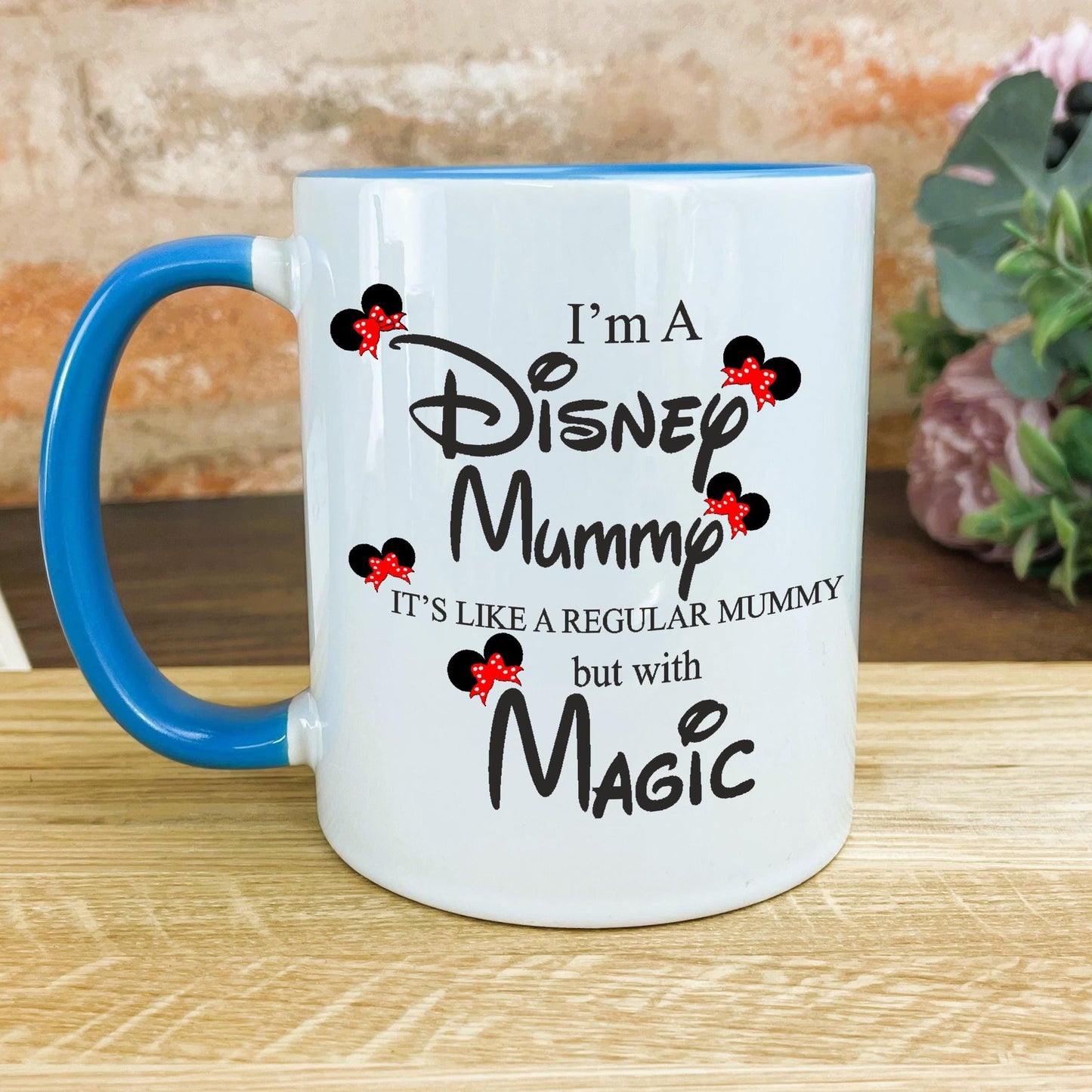 a blue and white coffee mug sitting on top of a wooden table