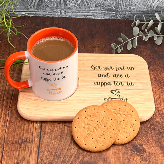 A wooden tray with a white mug and two cookies on it, placed on a wooden surface.