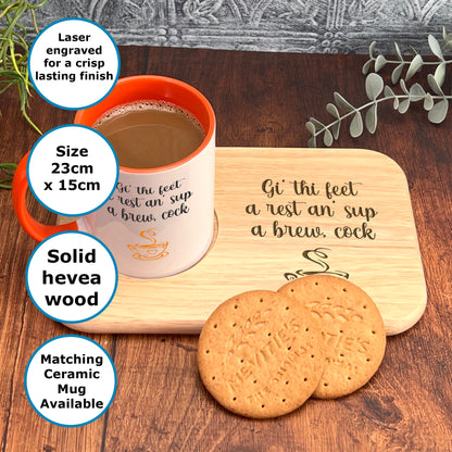 a wooden tray with a mug and two cookies on it, placed on a wooden surface.