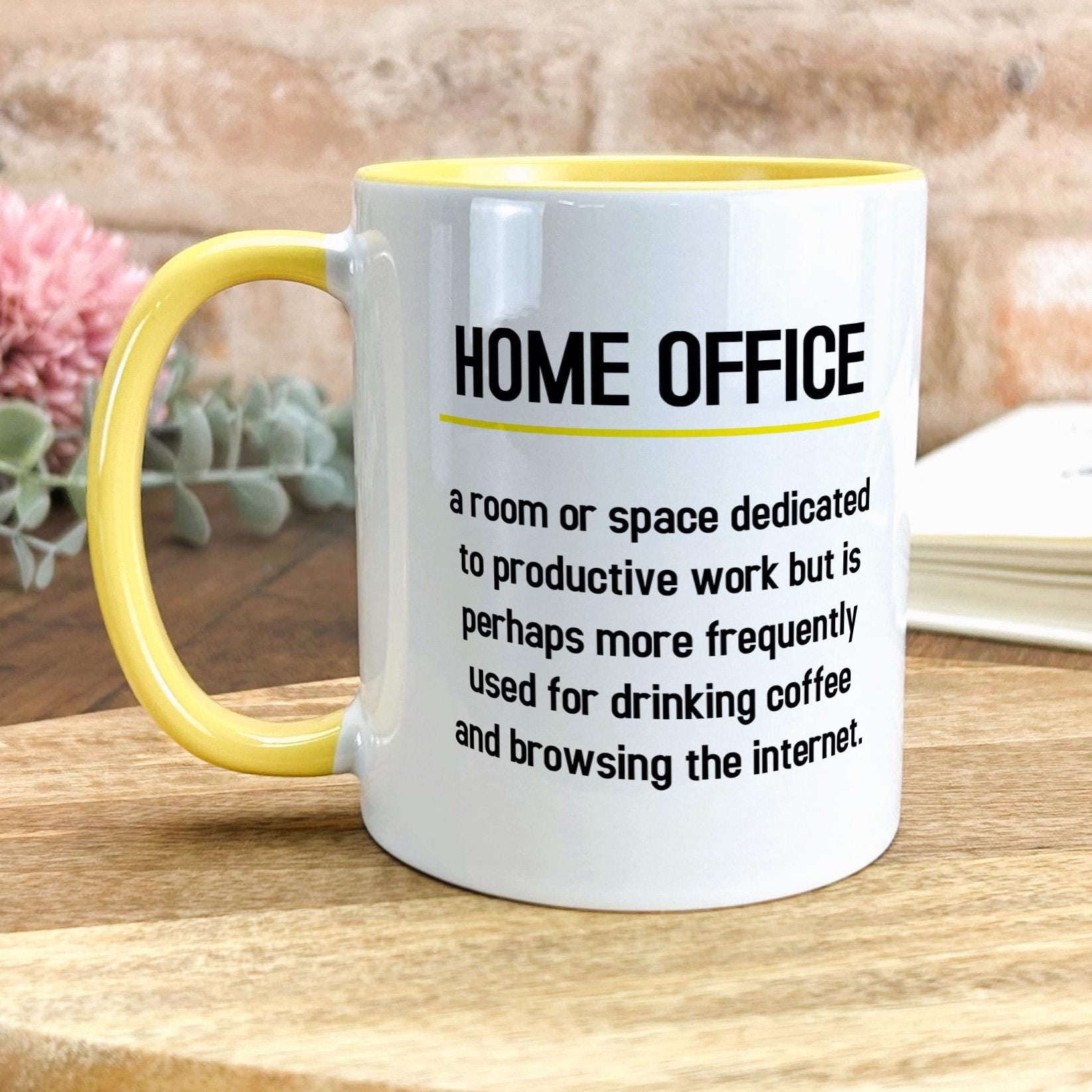 a yellow and white coffee mug sitting on top of a wooden table