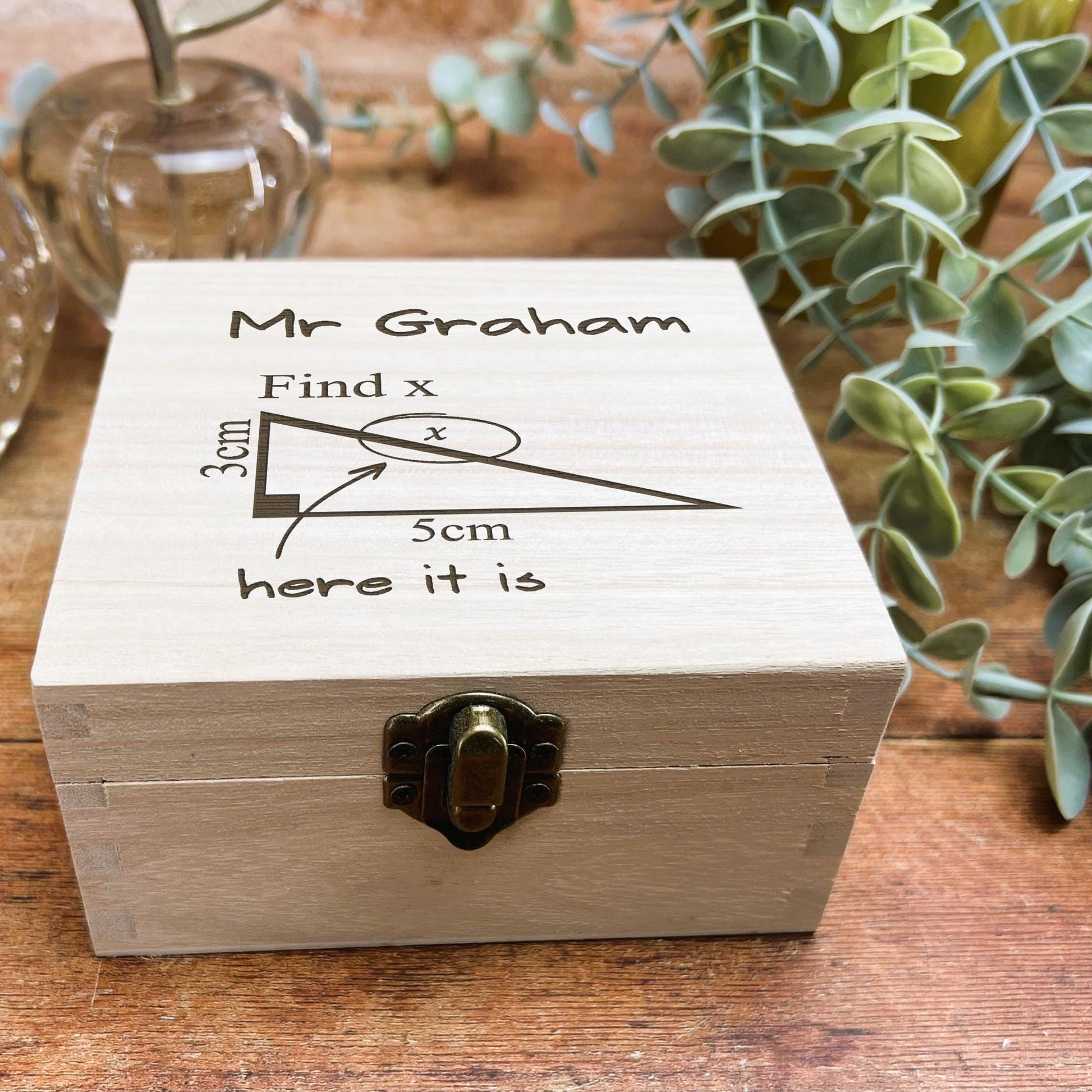 a wooden box sitting on top of a wooden table