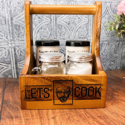 a wooden box with two jars of salt and pepper