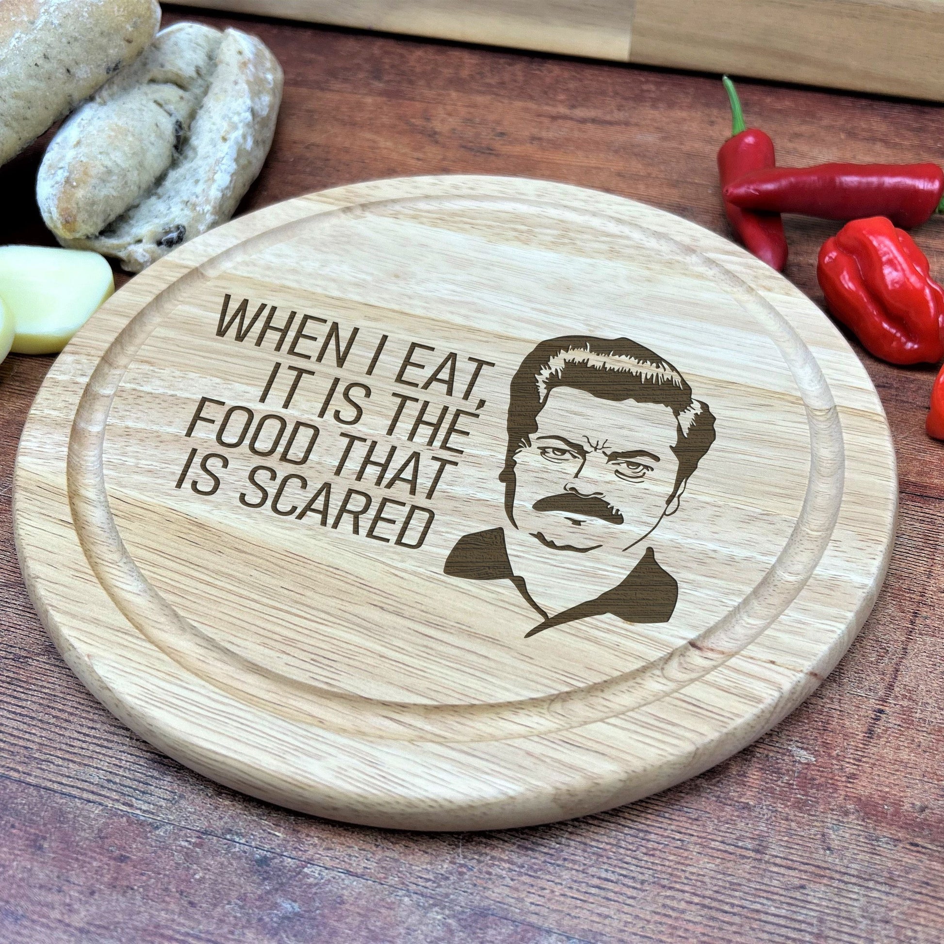 a wooden cutting board with a picture of a man on it