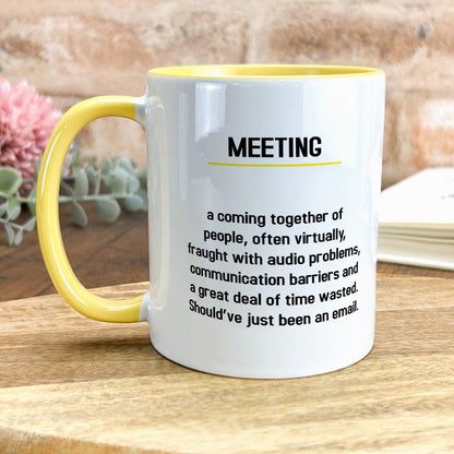 a yellow and white coffee mug sitting on top of a wooden table