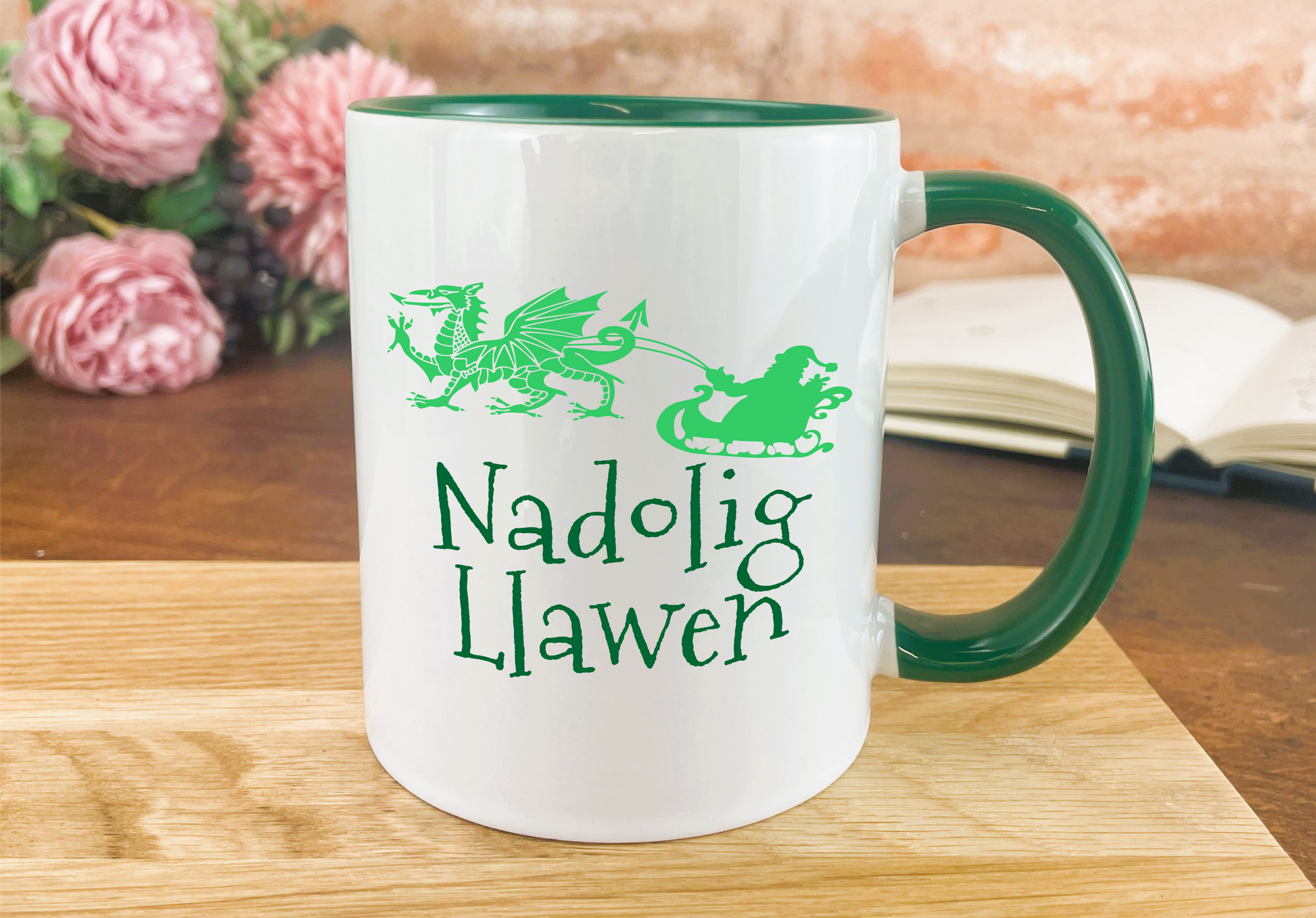 a green and white coffee mug sitting on top of a wooden table