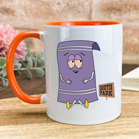 A white mug with an orange handle, featuring a cartoon character resembling a towel from the South Park television series.
