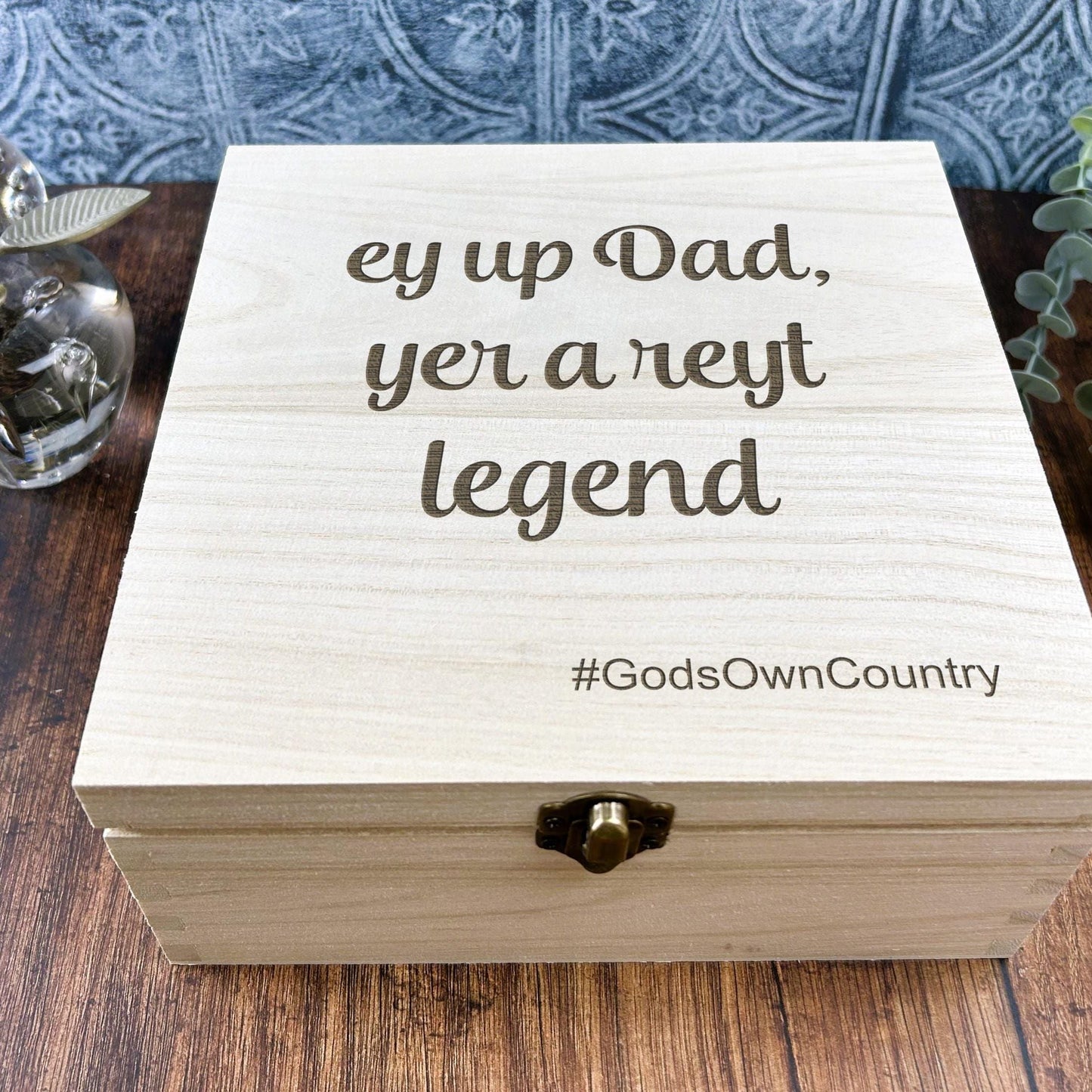 a wooden box sitting on top of a wooden table