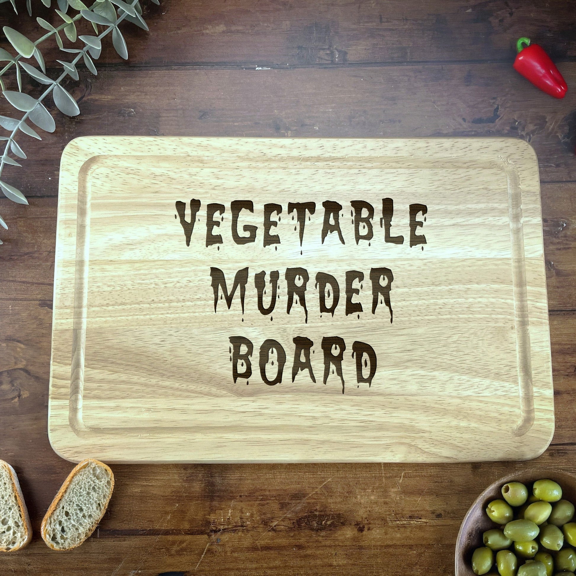 a wooden cutting board with the words vegetable murder board on it