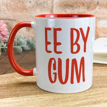 a red and white coffee mug with the words ee by gum on it