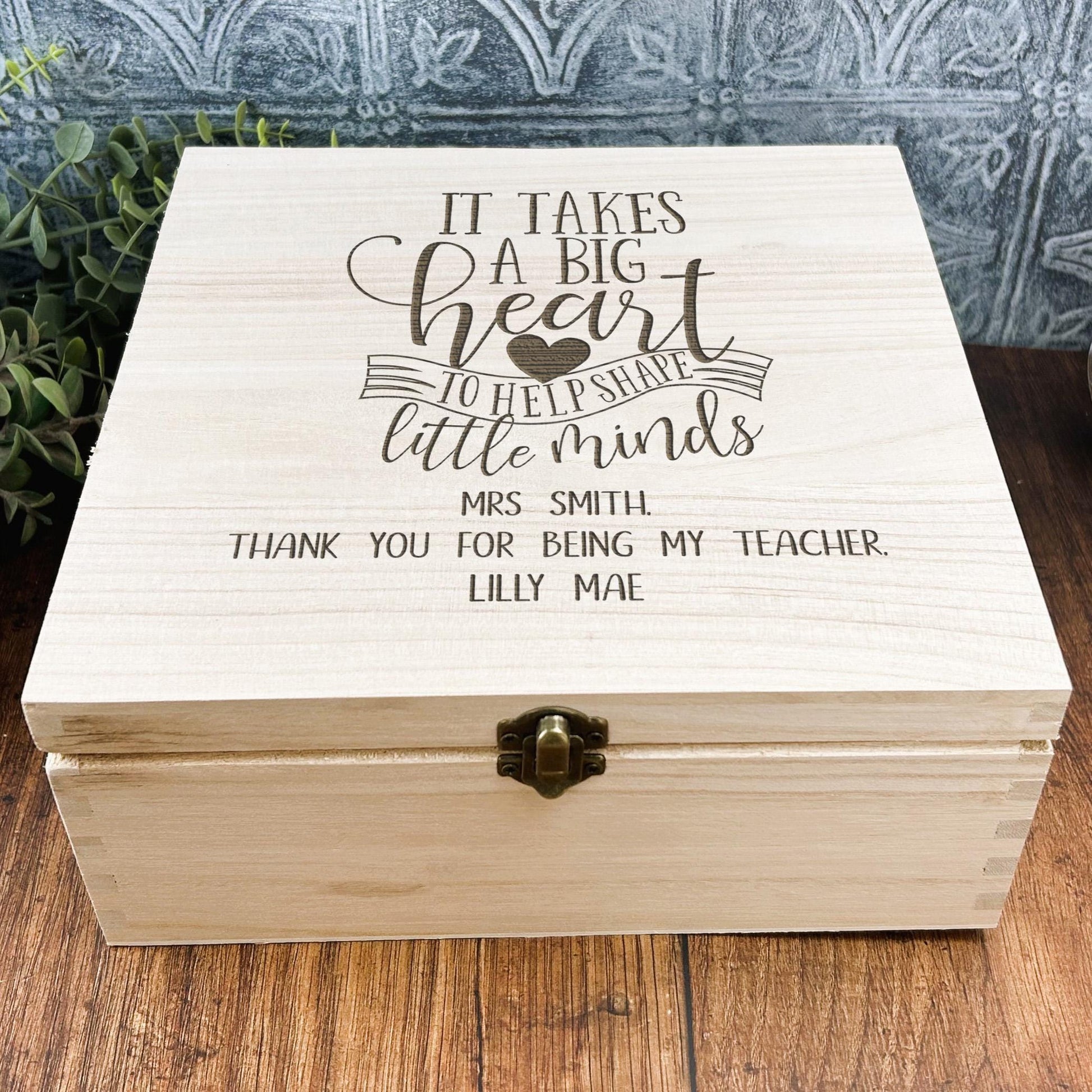 a wooden box that says it takes a big heart to teach little minds