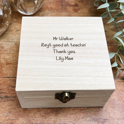 a wooden box sitting on top of a wooden table