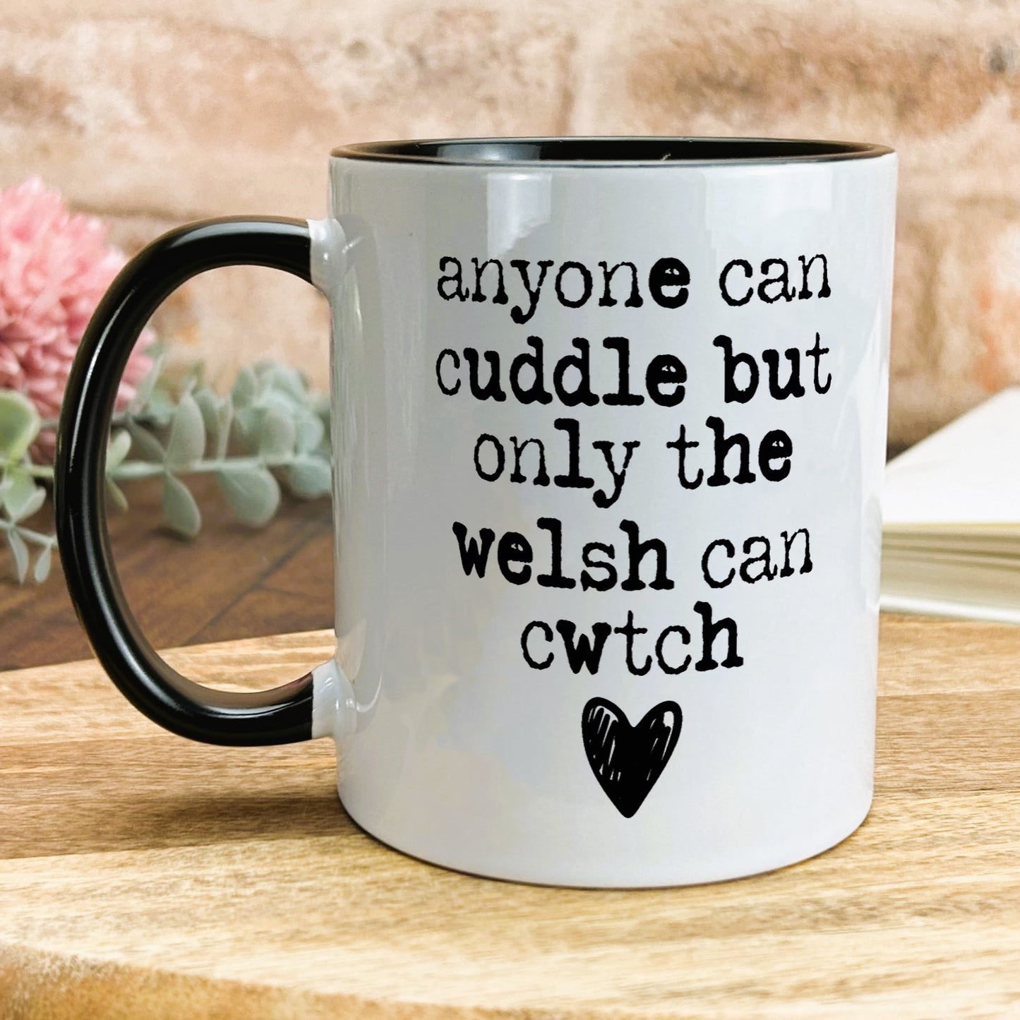 a black and white coffee mug on a wooden table