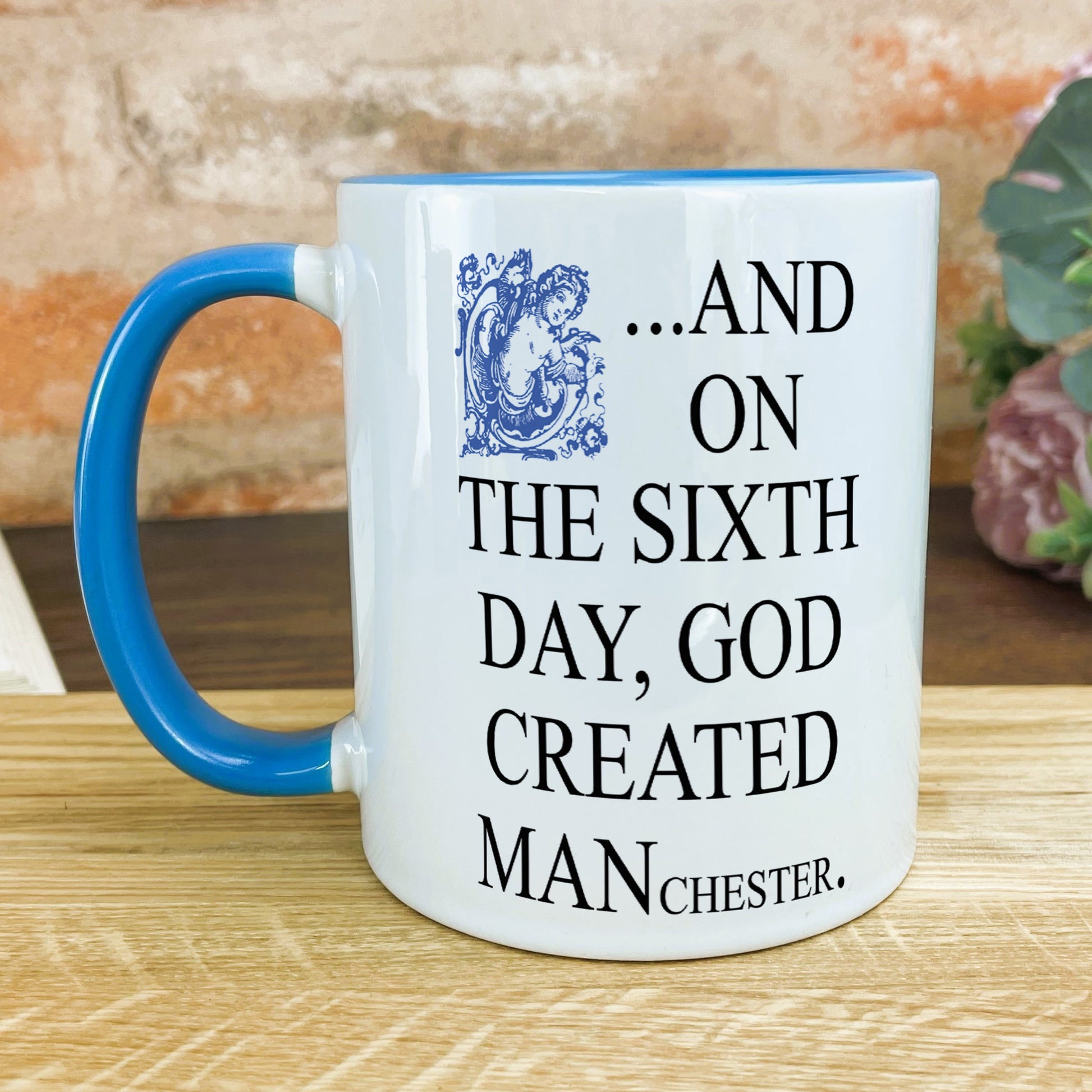 a blue and white mug sitting on top of a wooden table